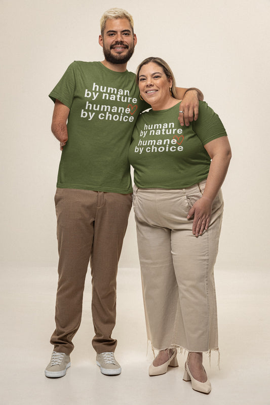 couple hugging each other wearing olive green T-shirt with the text 'human by nature humans by choice' printed on it.