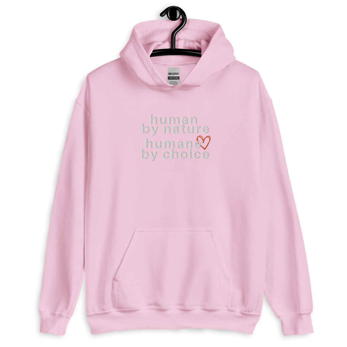 light pink hoodie with "Human by nature, humane by choice" graphic on front with red heart outline behind the "e" in humane