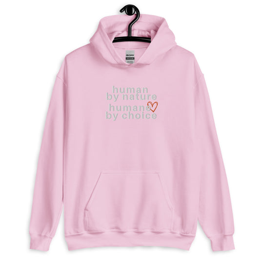 light pink hoodie with "Human by nature, humane by choice" graphic on front with red heart outline behind the "e" in humane