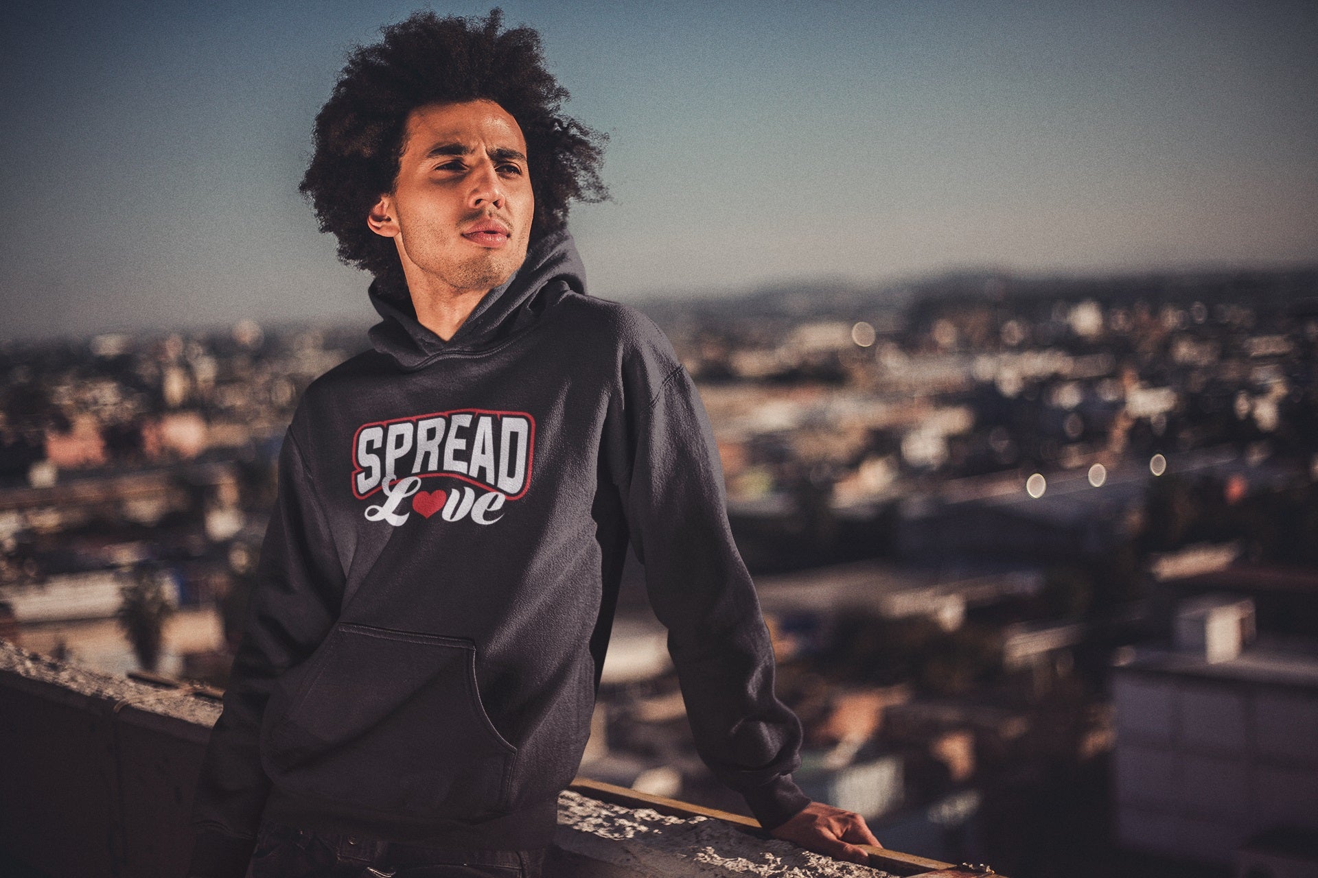 black man with afro wearing black Nelalena Spread Love Heart hoodie