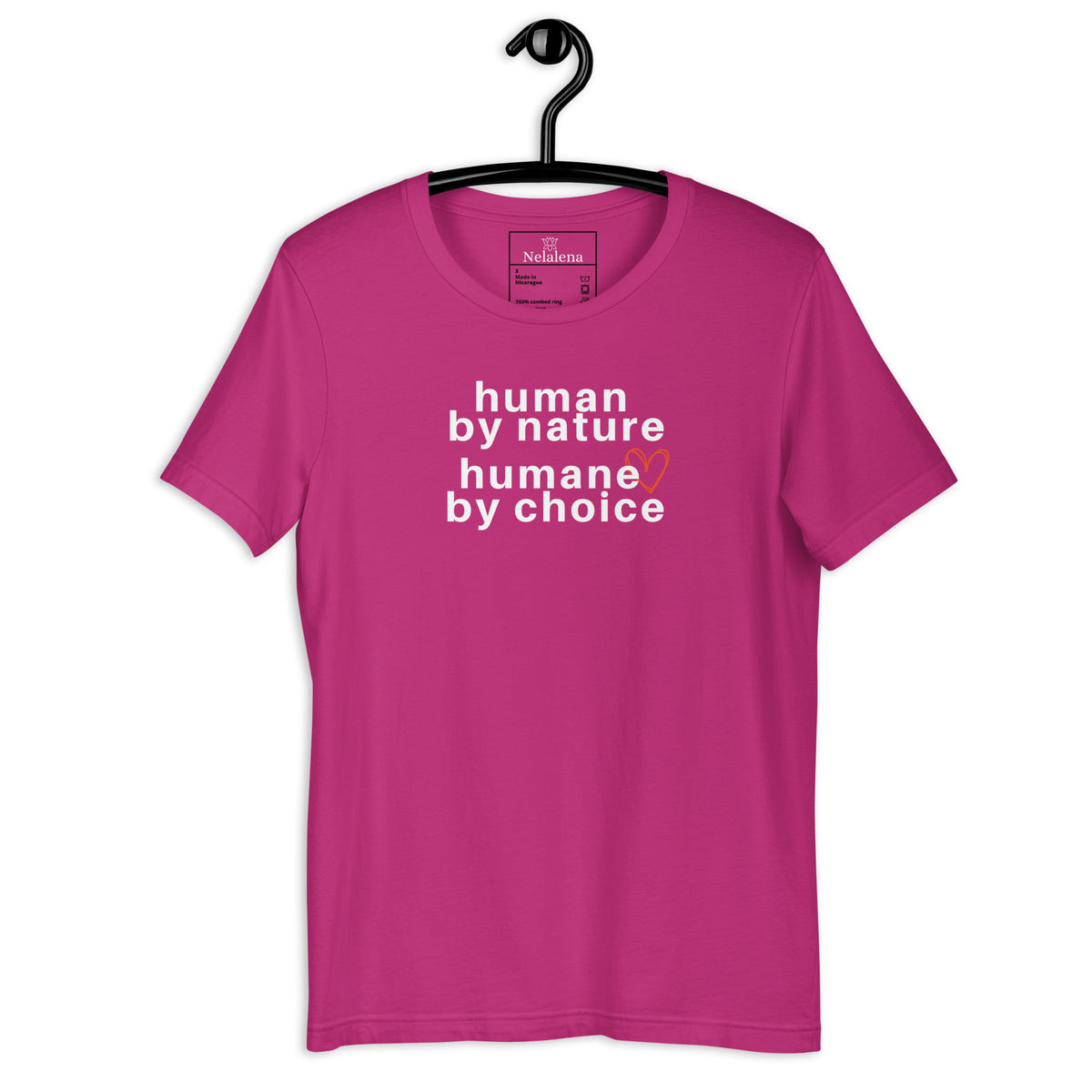 A dark pink short-sleeve t-shirt hanging on a black hanger against a white background, featuring the text 'human by nature humane by choice' in white with a small orange heart accent.