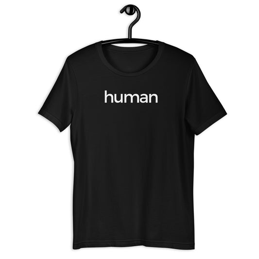 A black t-shirt hanging on a black hanger against a white background, featuring the word 'human' printed in white lowercase letters across the chest.