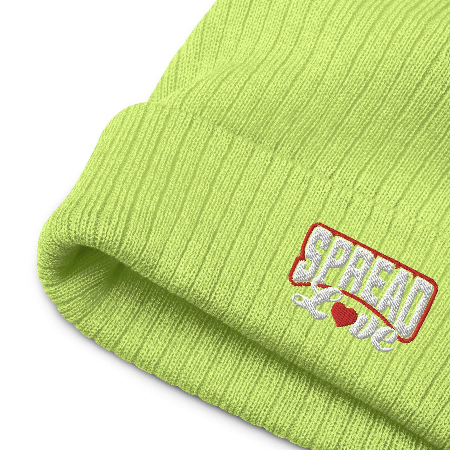 up close image of acid green ribbed knit beanie with "spread love" white text written on the fold 