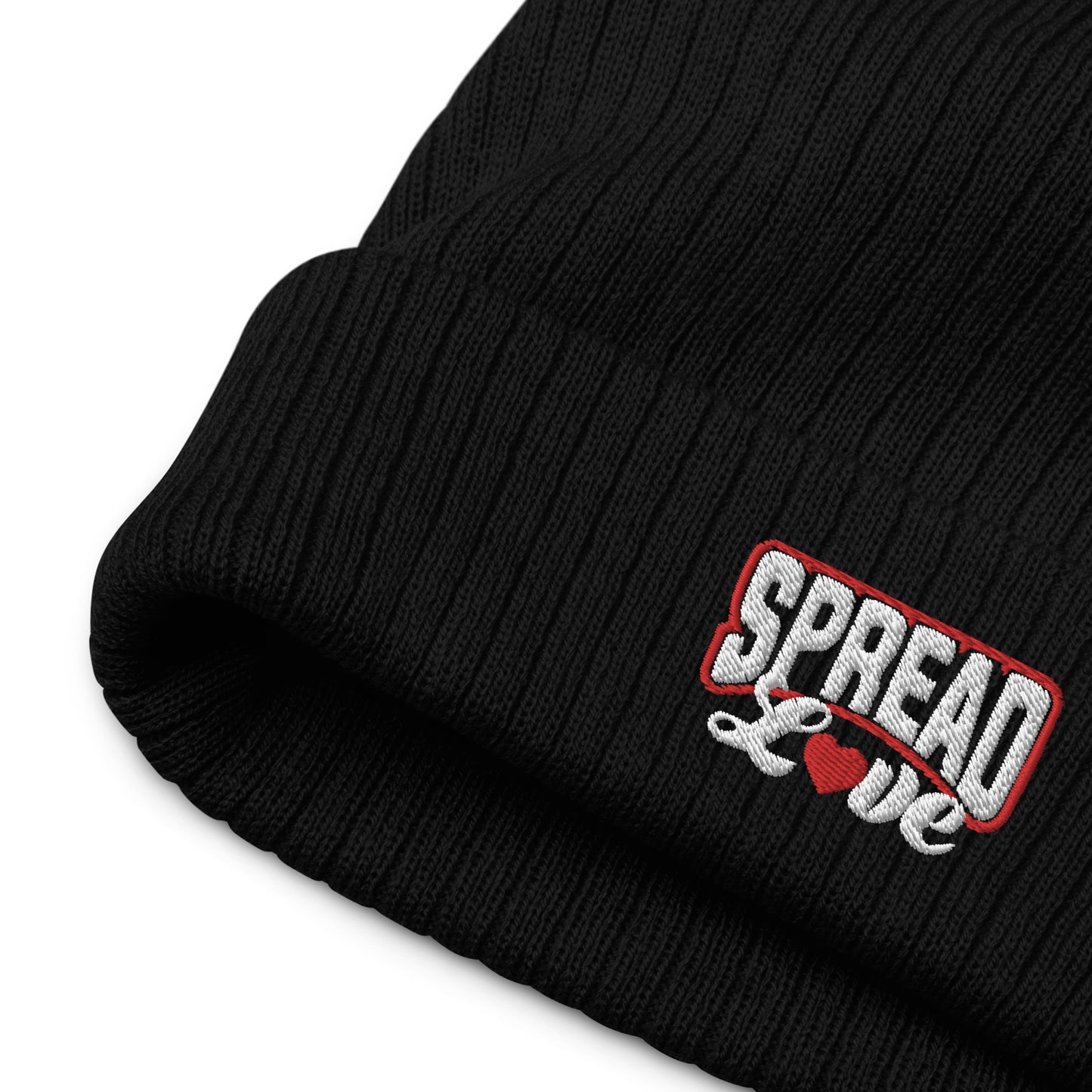 up close of black ribbed knit beanie with "spread love" white text written on the fold 