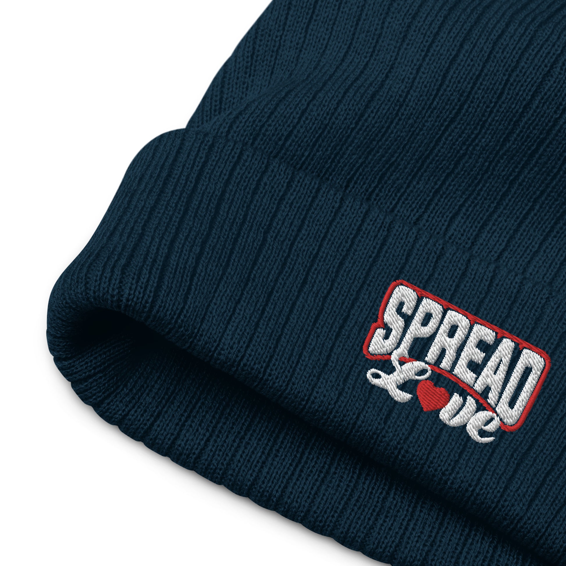 navy blue ribbed knit beanie with "spread love" white text written on the fold - up close